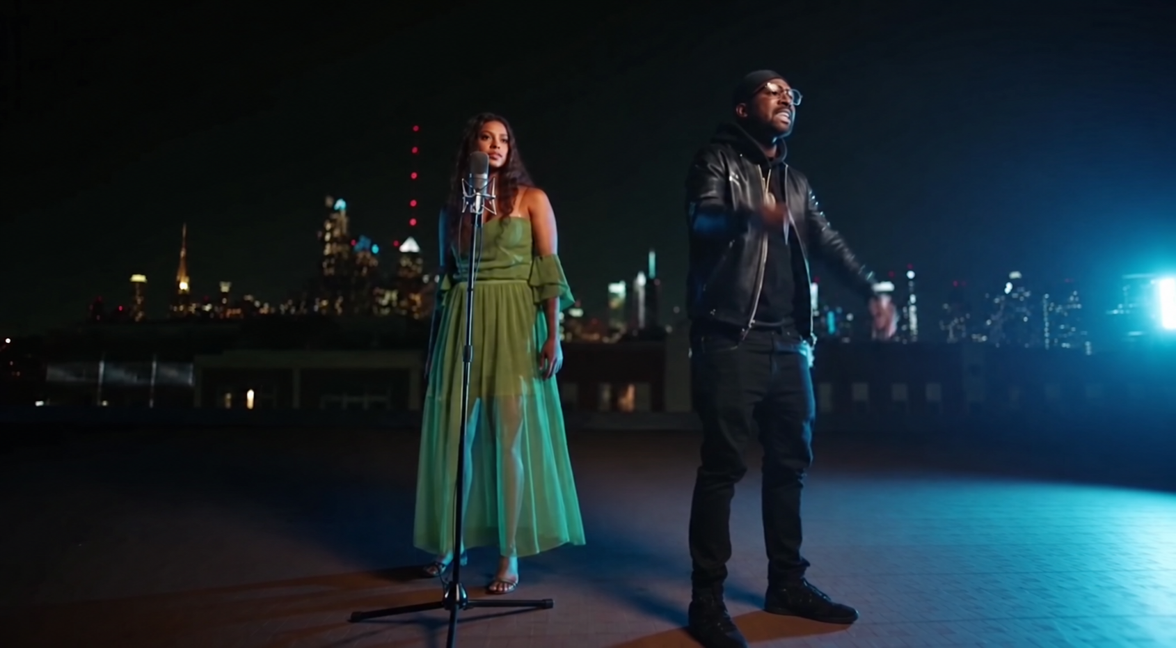 Supplied performance scene with two artists on a nighttime stage